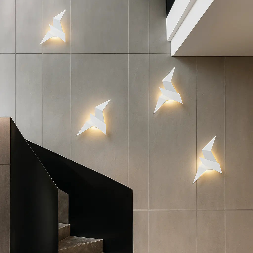 ORLUNE HOME Origami LED wall lights glow softly, sculptural and bird-like, elegantly illuminating.