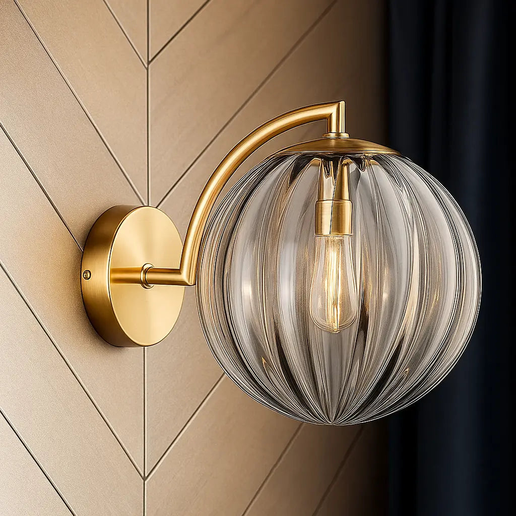 ORLUNE HOME brass wall light: gold arm, globe glass, exposed bulb—chic illumination defined.