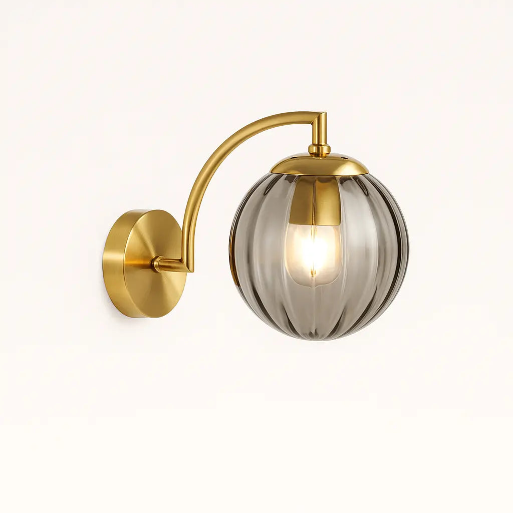 This chic wall light’s ribbed glass globe emits a warm, stylish glow. Pure retro elegance.