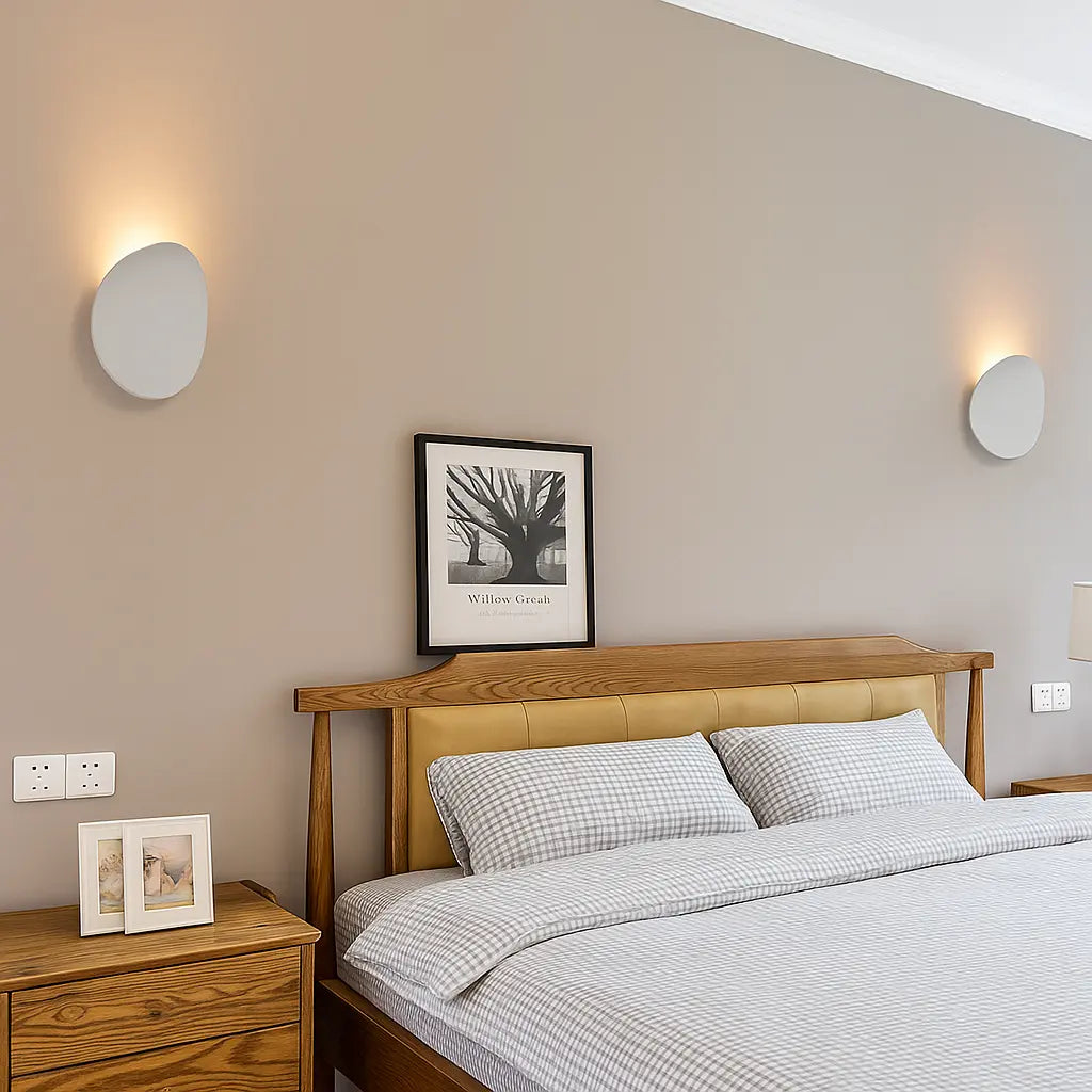 Two sleek ORLUNE HOME LED wall lights create a soft, modern bedroom glow.