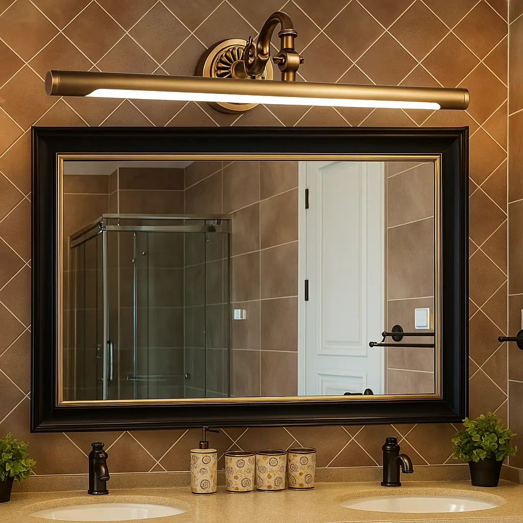 Warm brass gold LED lighting above the mirror creates a cozy, inviting bathroom glow.