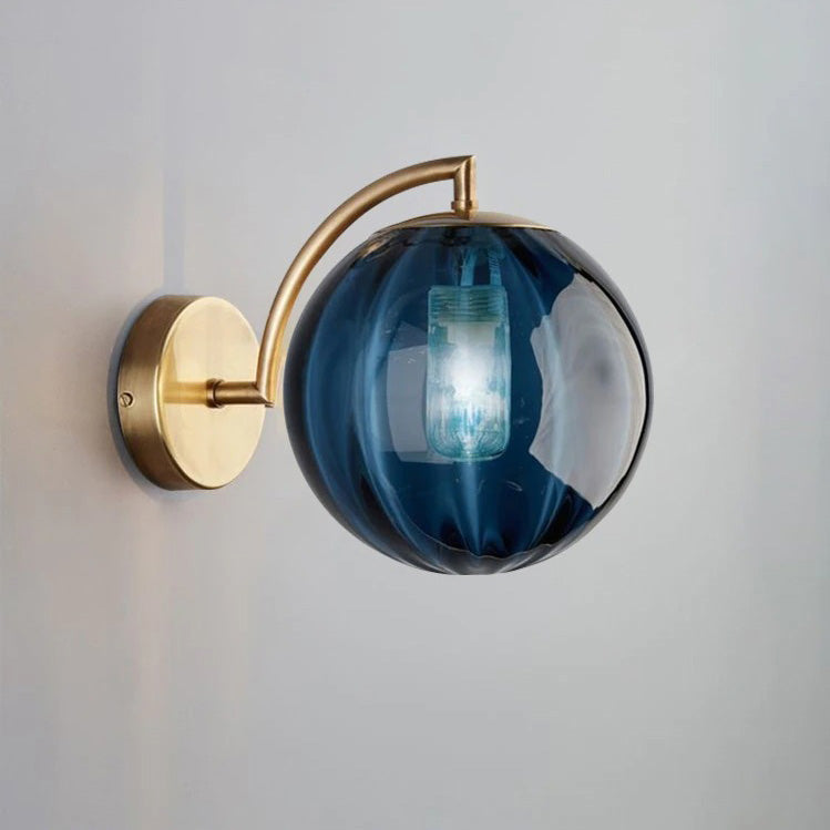 Soft ambient lighting streams from a smoked glass globe with visible bulb and brass base.