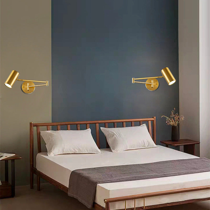 Sleek gold aluminum wall lights above the bed add modern, integrated lighting elegance.