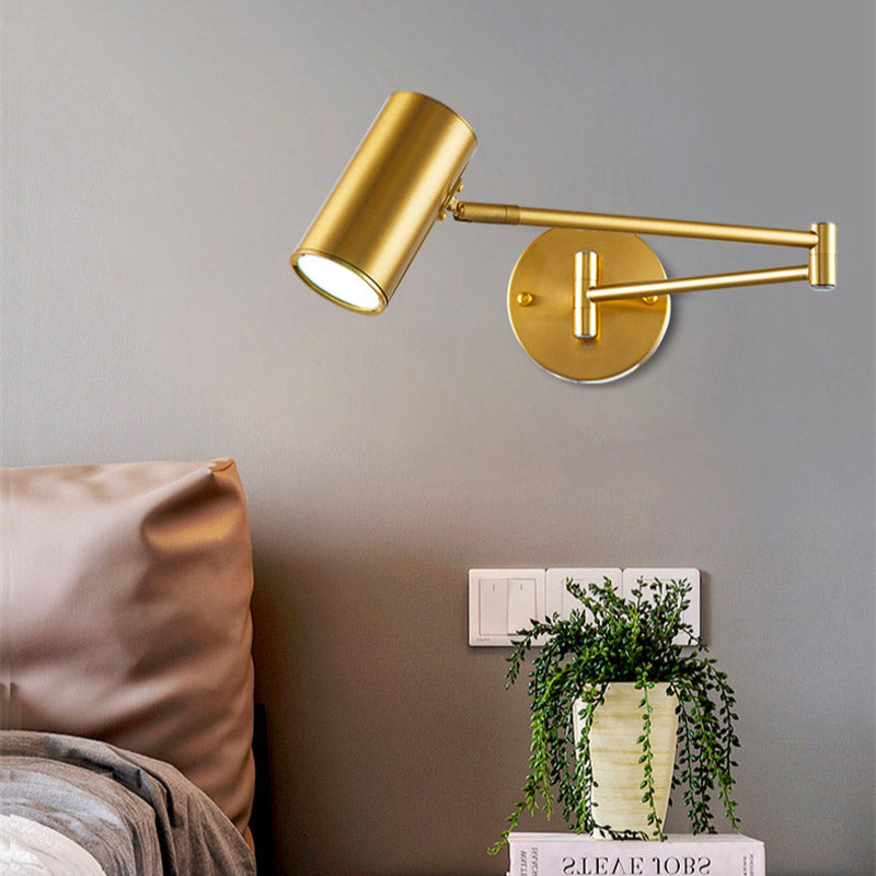 The gold aluminum wall light with adjustable arm provides stylish and customizable illumination above the bed.