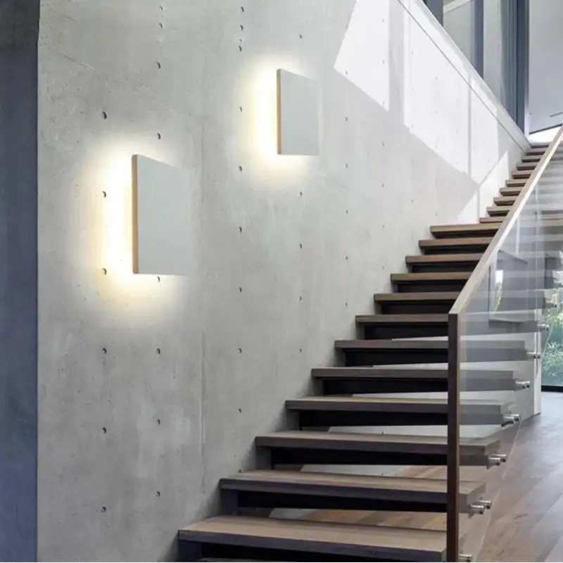 Soft-glowing wall lights and streaming natural light create a bright, welcoming ambiance.